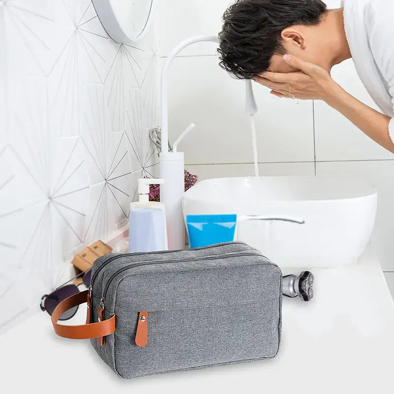 Travel Toiletry Bag for Skincare Storage next to a sink with a person washing their face.