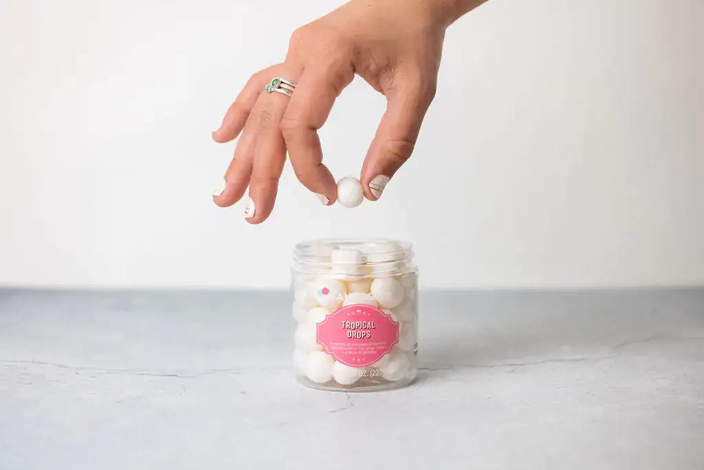 Pampering Natural Skincare gift for New Mom with a hand reaching for moisturizing skincare products in a jar.