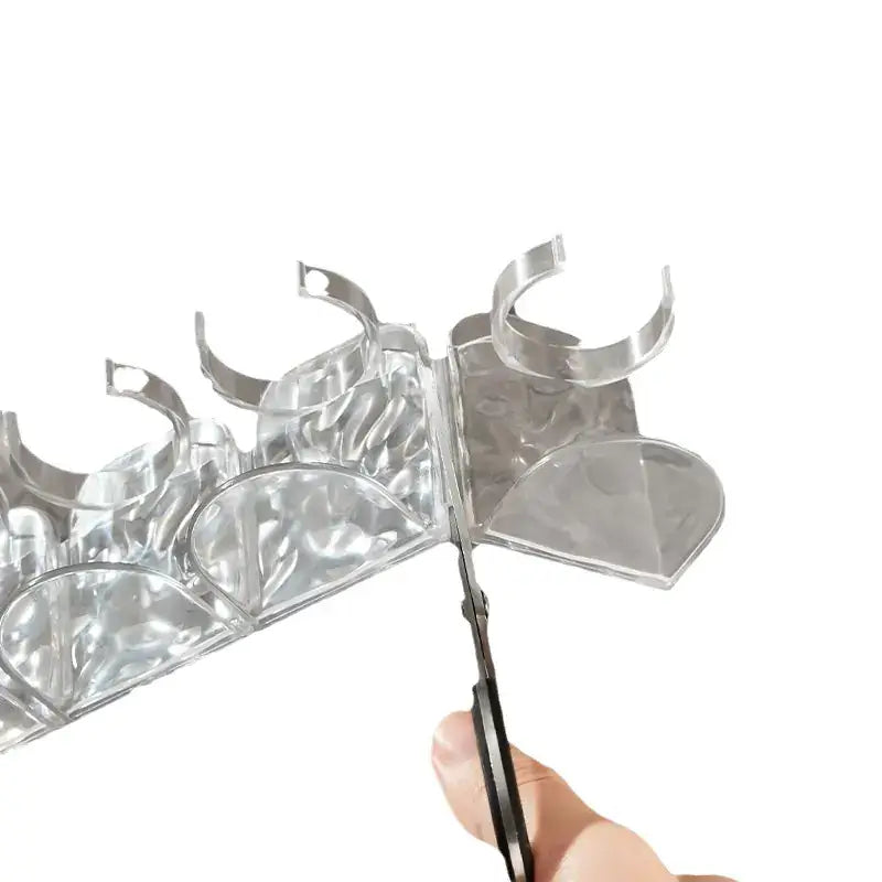 Person using scissors to customize the Glacier Pattern Bathroom Organizer for Skincare.