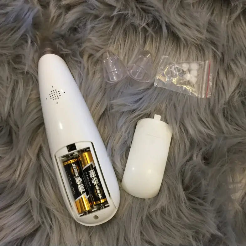 Blackhead Removal Device for Pore Cleansing and Skincare with battery compartment and accessories.