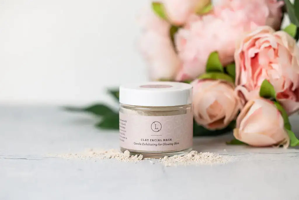 Pampering Natural Skincare gift for New Mom with clay facial mask beside pink peonies.